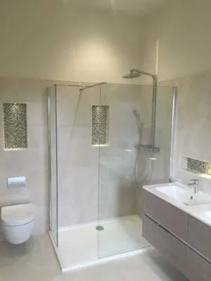 New bathroom with large glass shower enclosure