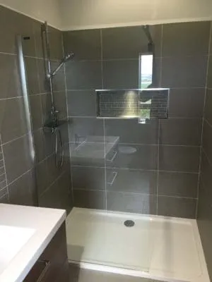 modern shower with grey tiles